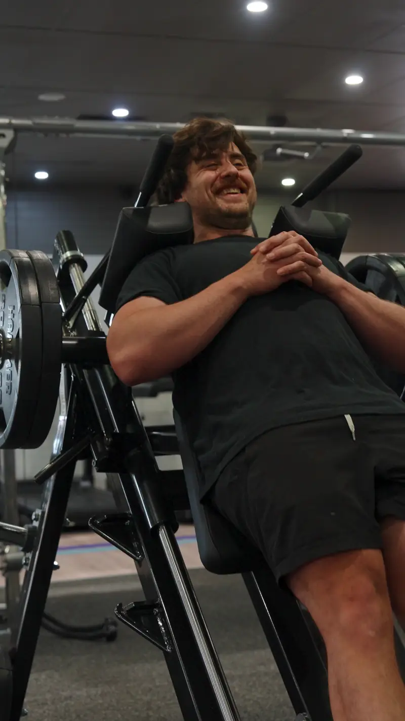 Michael grinning on the hack squat