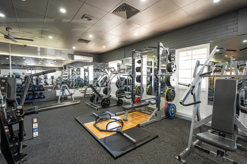 A half rack loaded with bumper plates