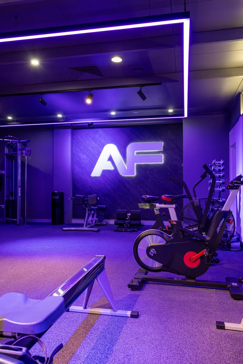 Bikes and a rower under the AF wall