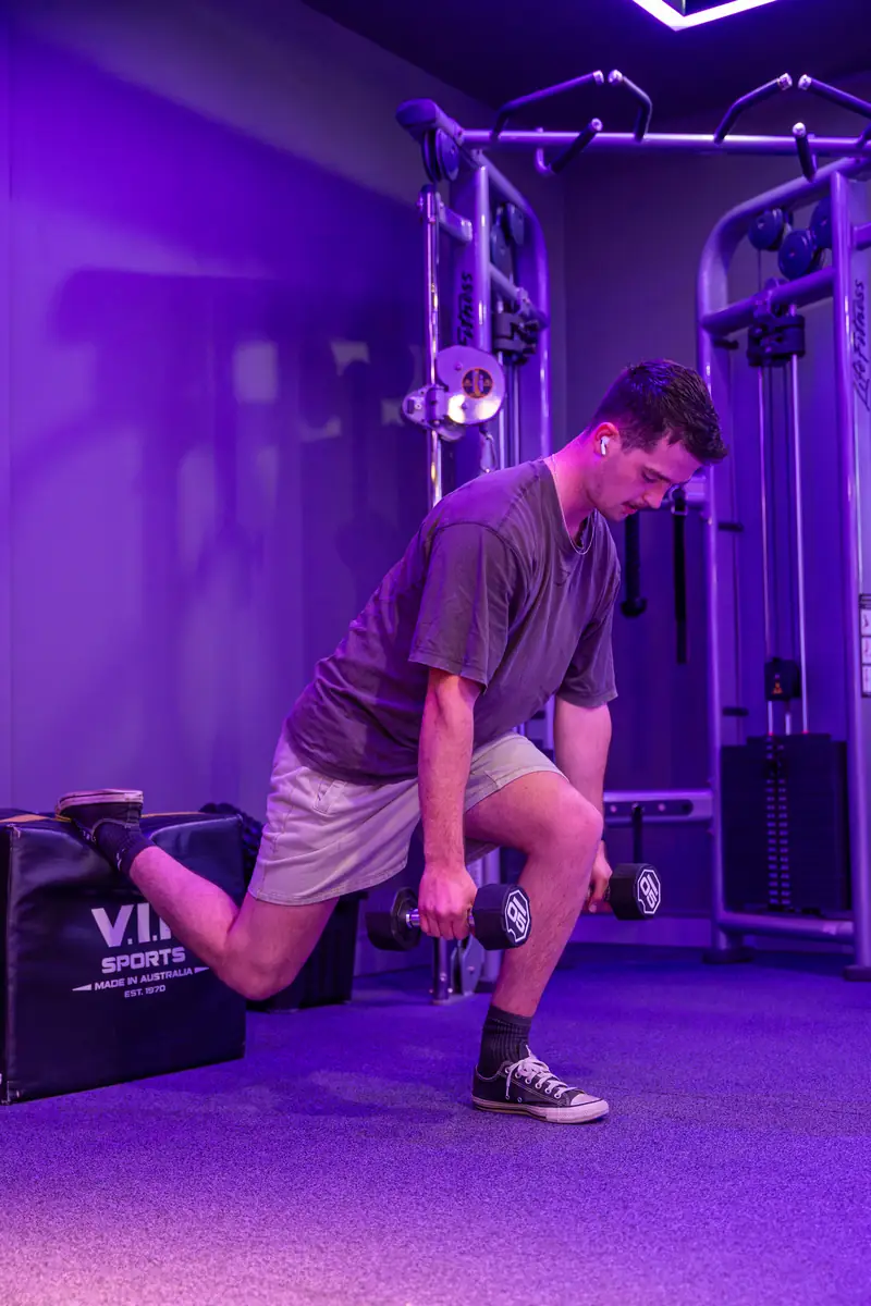 A member doing split squats